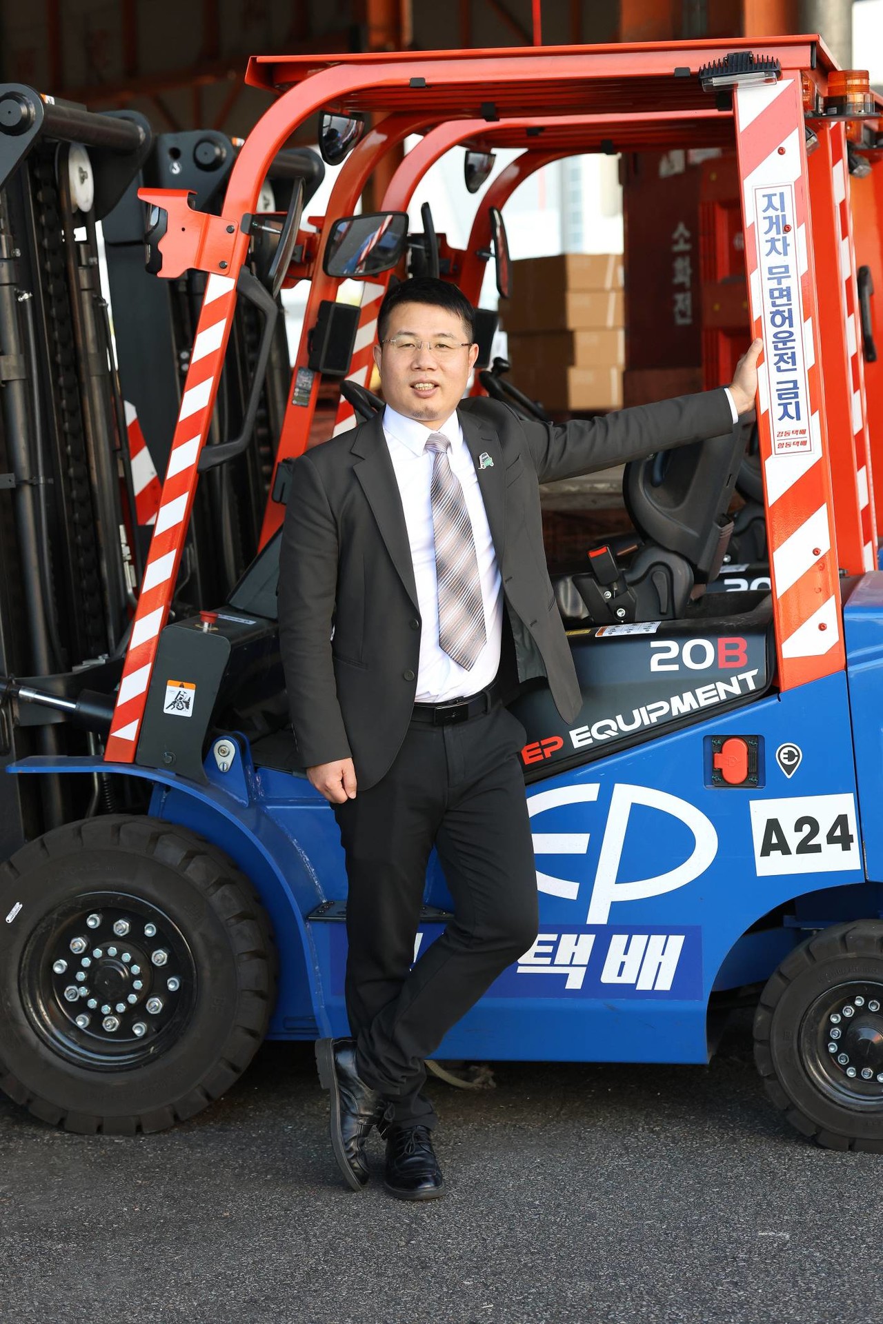△파머 자오(Farmer Zhao) 이피이큅먼트 부사장이 경동택배에 납품된 자사의 전동 지게차 EFL20B 앞에서 포즈를 취하고 있다. 이피이큅먼트는 경동택배의 요구에 따라 EFL203모델의 파생 모델인 EFL20B를 생산했다
